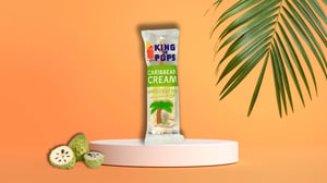 Caribbean Cream pop against orange background with tropical leaf