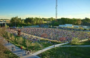 Overhead shot of hundreds of people doing yoga in the Old Fourth Ward Skatepark park in Atlanta, GA